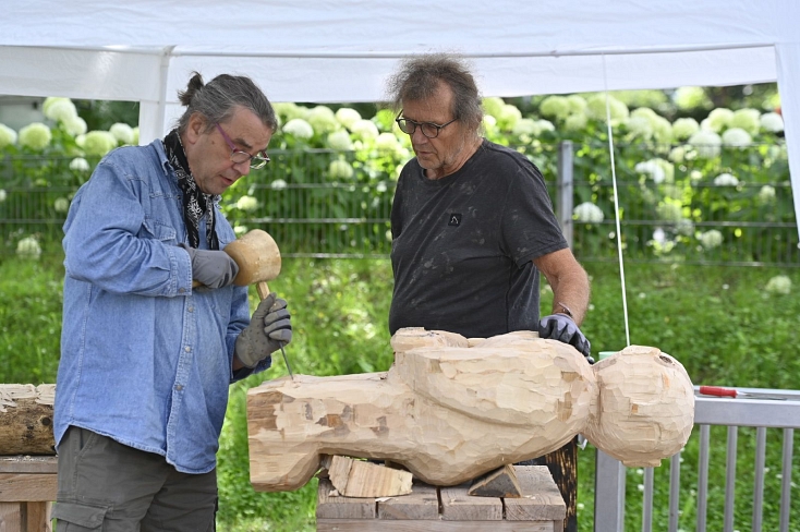 Zwei Teilnehmer des Kurses von Lilian Hasler bei der Sommerakademie 2021 schaffen eine Skulptur aus Holz © Georg Kronenberg