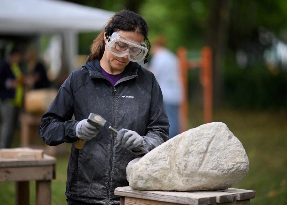 Sommerakademie: Kurs Monika Bodenmüller, Stein-Bildhauerei Kursteilnehmerin bearbeitet einen Stein. © Georg Kronenberg