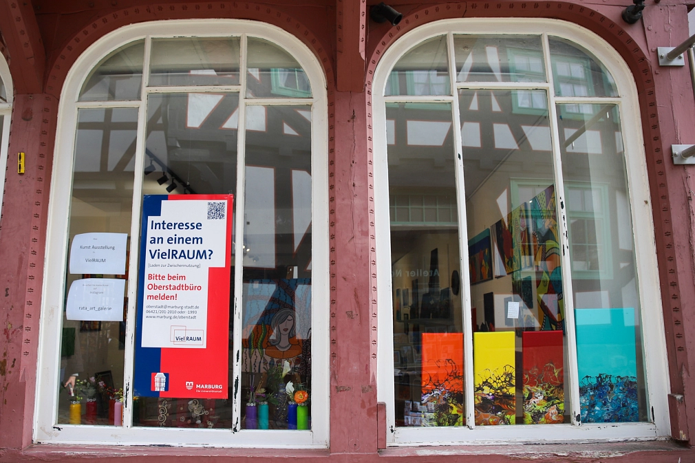 An der Schaufensterscheibe eines Ladens in der Augustinergasse hängt ein Plakat, dass auf das VielRAUM-Projekt aufmerksam macht.&nbsp;&copy;&nbsp;Stefanie Ingwersen, Stadt Marburg